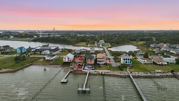 a front view of a house with a yard and a garage