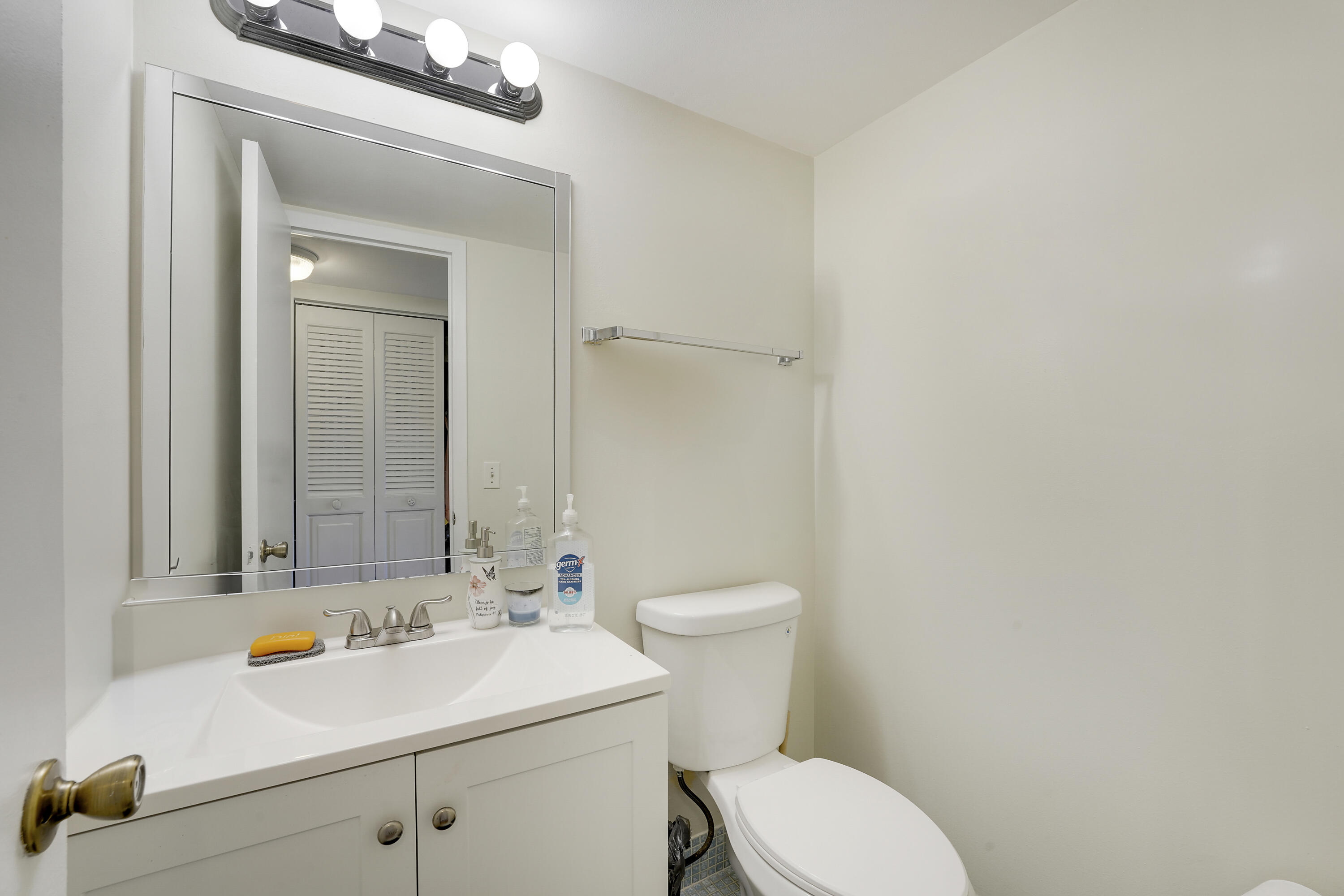 146 Mansfield D Boca Raton, FL 33434 - Photo 8 of 12 a bathroom with a sink a toilet and mirror