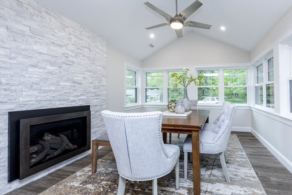 7 Elm Street North Reading, MA 01864 - Photo 11 of 42 a dining room with furniture a fireplace and wooden floor