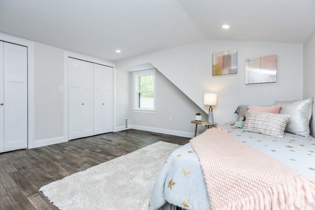 7 Elm Street North Reading, MA 01864 - Photo 28 of 42 a bedroom with a large bed and a chandelier