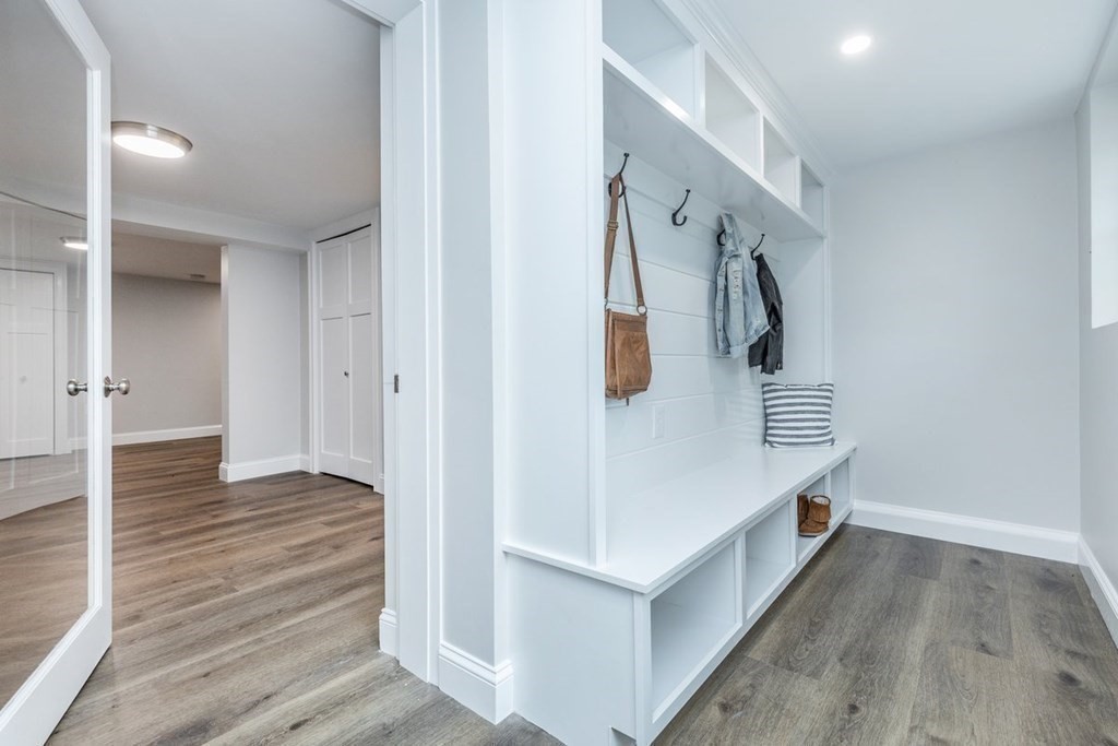 7 Elm Street North Reading, MA 01864 - Photo 36 of 42 a view of a hallway with wooden floor and staircase