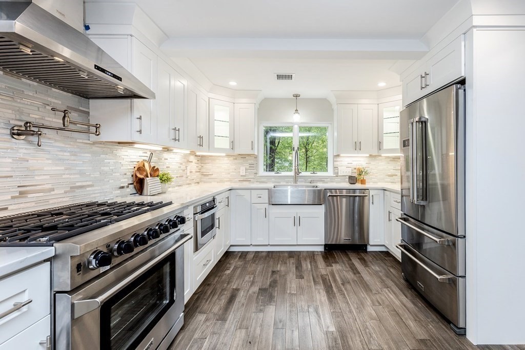 7 Elm Street North Reading, MA 01864 - Photo 6 of 42 a kitchen with a sink a counter top space stainless steel appliances and cabinets