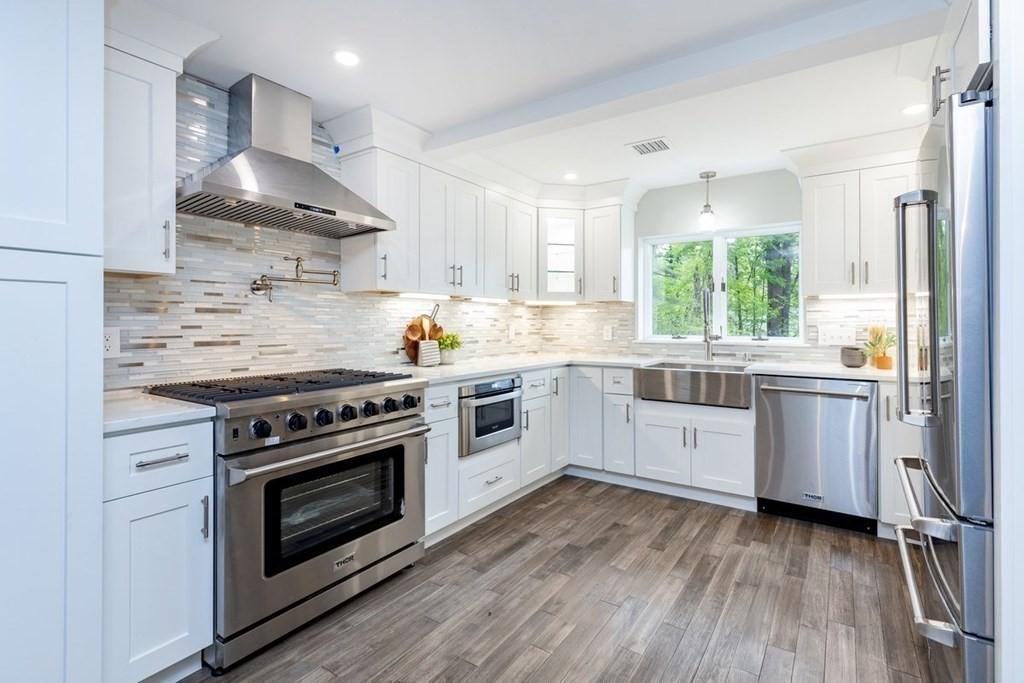 7 Elm Street North Reading, MA 01864 - Photo 7 of 42 a kitchen with a stove a sink and a refrigerator