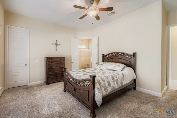a bedroom with a bed and ceiling fan