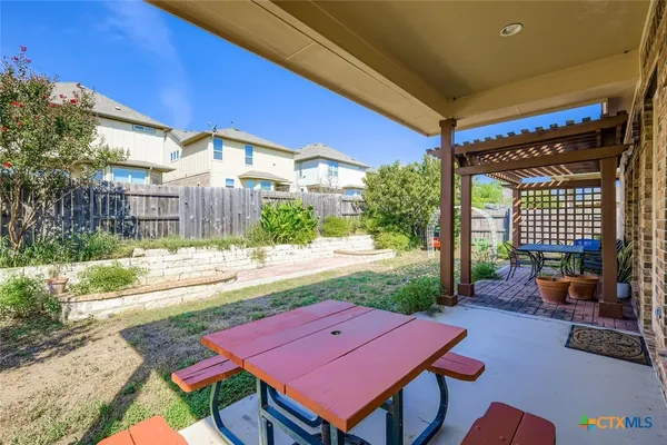 a view of a house with backyard and a tree