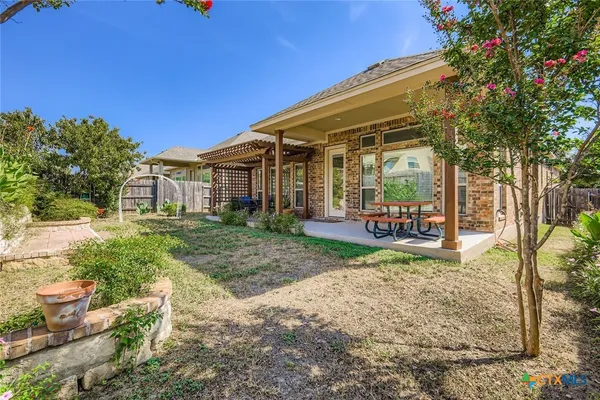 a view of a house with backyard porch and sitting area