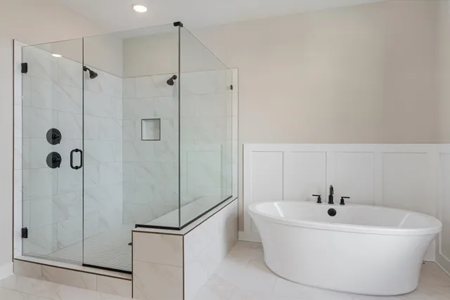 a white bath tub sitting next to a shower