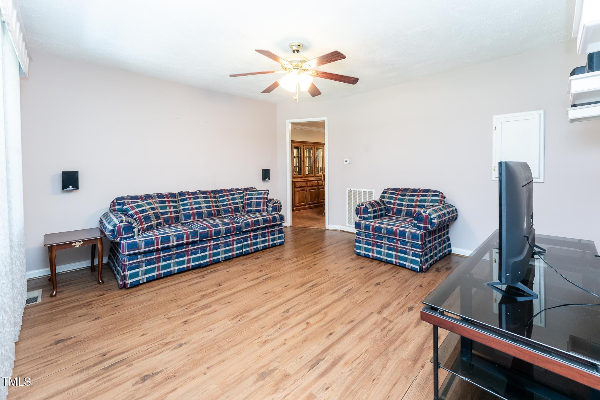 2809 Providence Road Raleigh, NC 27610 - Photo 20 of 39 a living room with furniture a ceiling fan and a rug