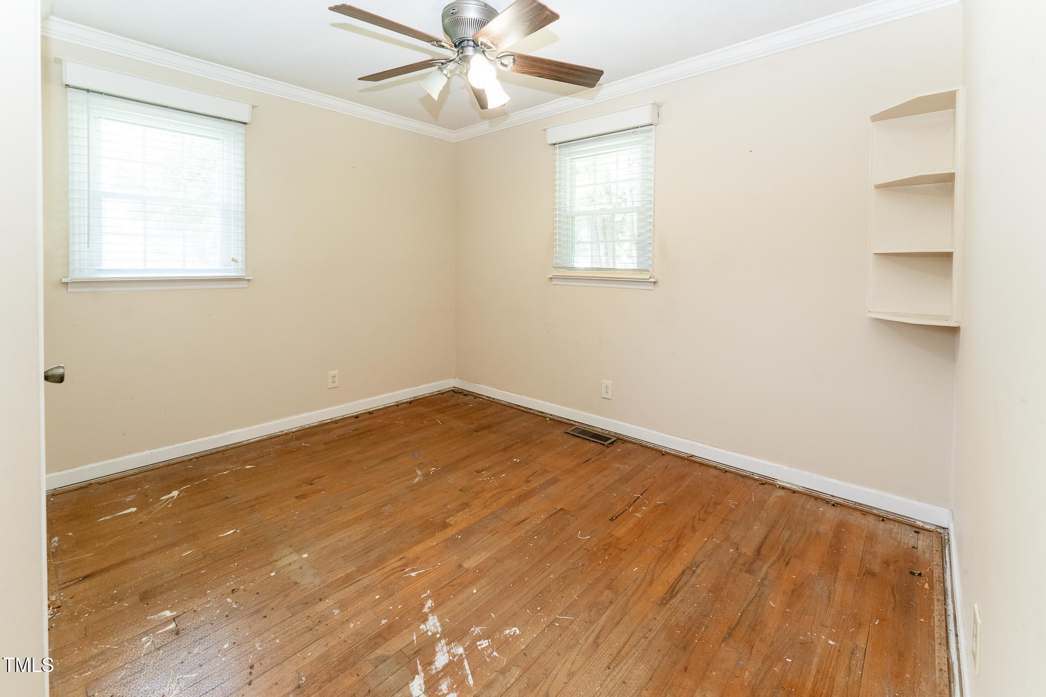 2809 Providence Road Raleigh, NC 27610 - Photo 26 of 39 a view of a room with wooden floor and a ceiling fan
