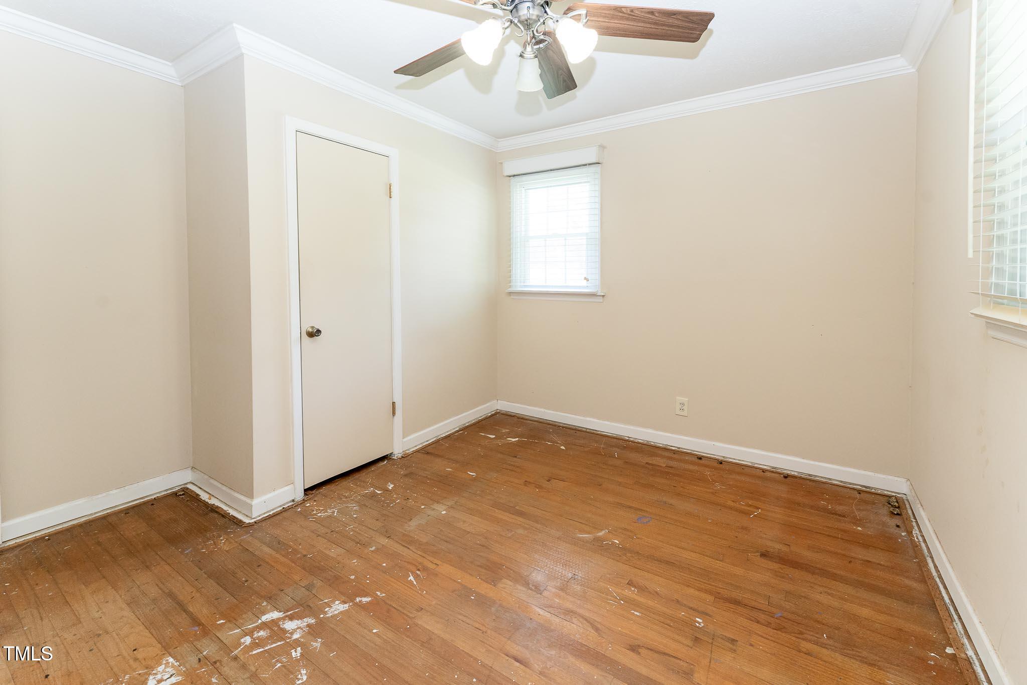 2809 Providence Road Raleigh, NC 27610 - Photo 27 of 39 an empty room with a chandelier fan and windows