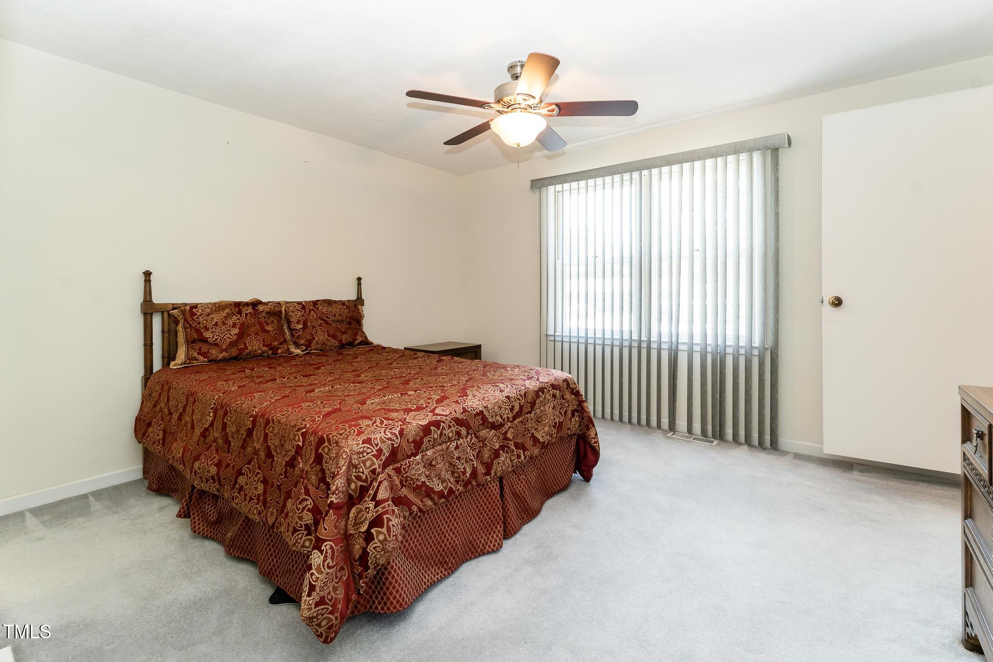2809 Providence Road Raleigh, NC 27610 - Photo 30 of 39 a bed sitting in a spacious bedroom next to a window