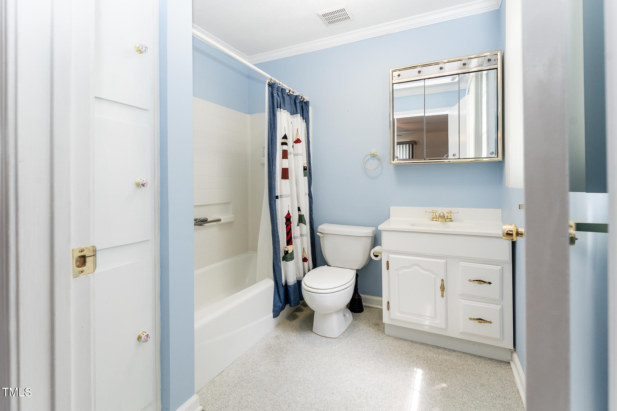 2809 Providence Road Raleigh, NC 27610 - Photo 32 of 39 a bathroom with a toilet sink vanity and mirror