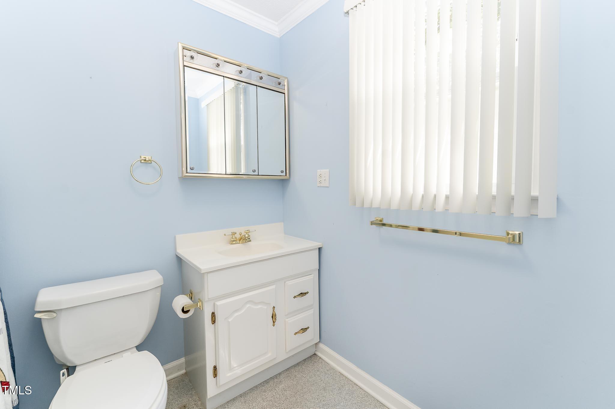 2809 Providence Road Raleigh, NC 27610 - Photo 34 of 39 a bathroom with a toilet sink and mirror