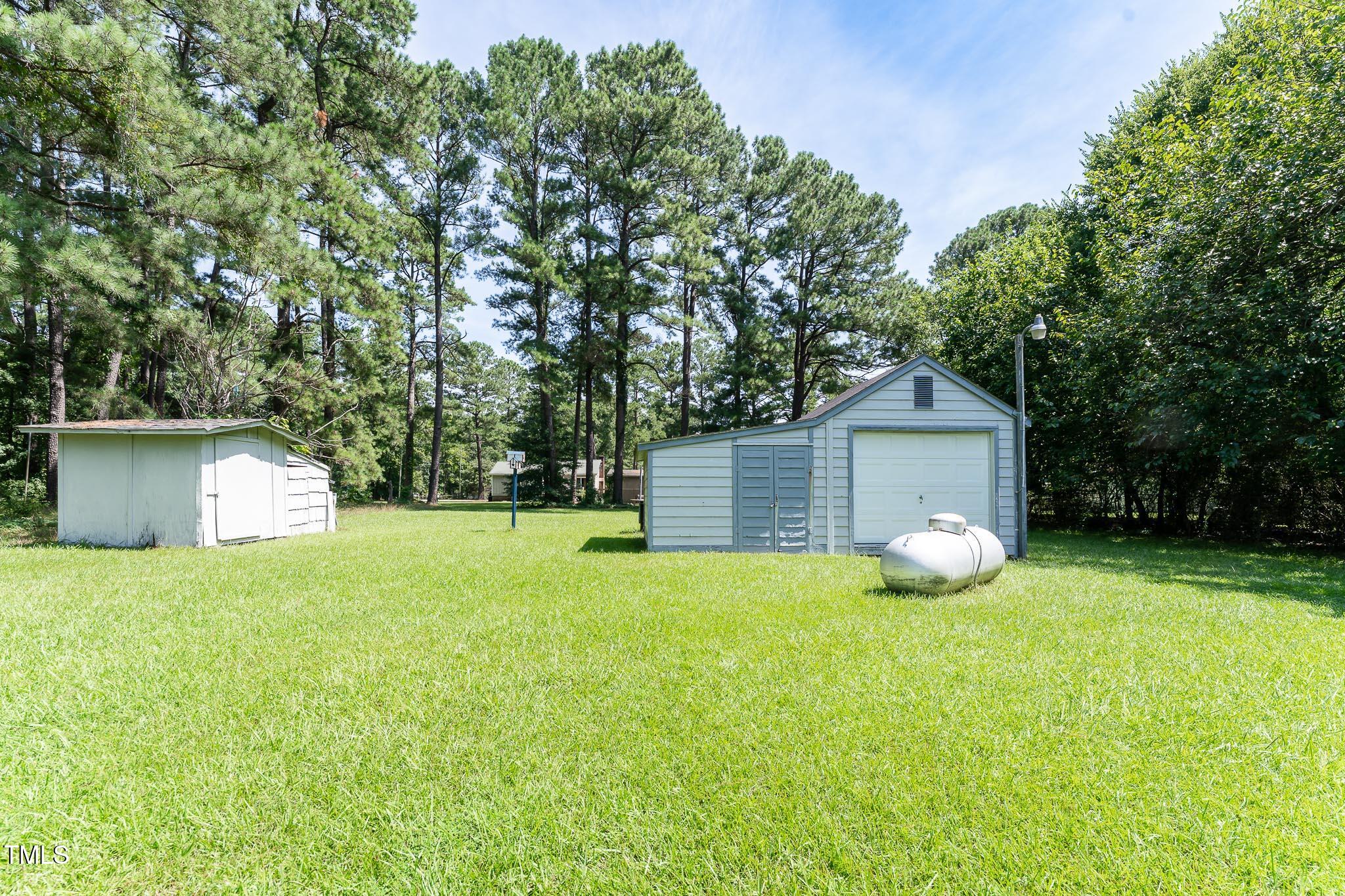 2809 Providence Road Raleigh, NC 27610 - Photo 7 of 39 a view of an house with backyard space and tree