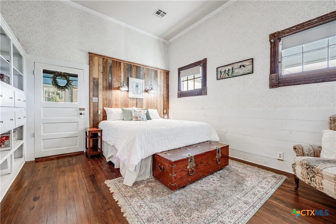 13471 Cedar Valley Road Salado, TX 76571 - Photo 15 of 41 a bedroom with a bed and wooden floor