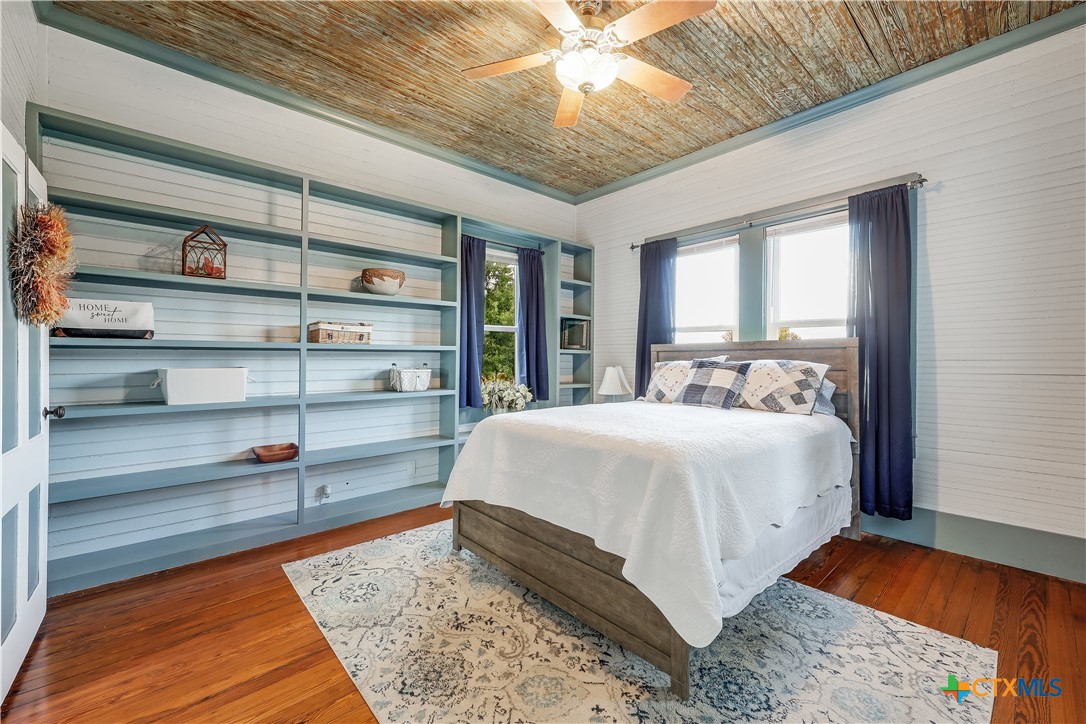 13471 Cedar Valley Road Salado, TX 76571 - Photo 28 of 41 a bed sitting in a bedroom next to a window