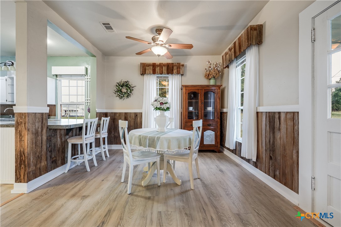 13471 Cedar Valley Road Salado, TX 76571 - Photo 34 of 41 a view of a dining room with furniture and wooden floor