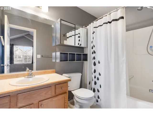 a bathroom with a sink toilet a shower and a mirror