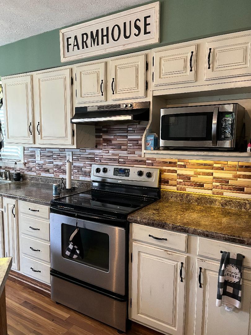 1532 North 2250th Road Ottawa, IL 61350 - Photo 12 of 38 a kitchen with stainless steel appliances granite countertop a stove and a microwave