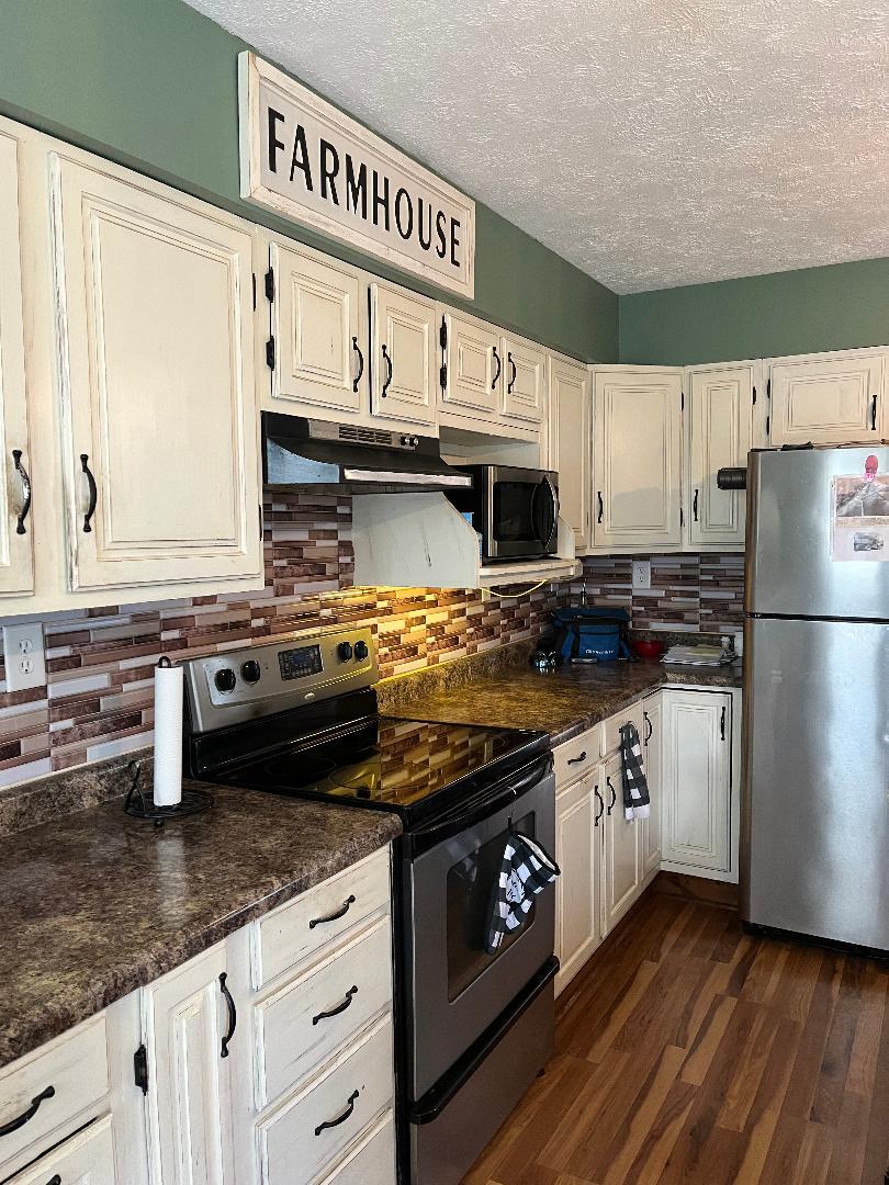 1532 North 2250th Road Ottawa, IL 61350 - Photo 15 of 38 a kitchen with stainless steel appliances granite countertop a stove a sink and a refrigerator