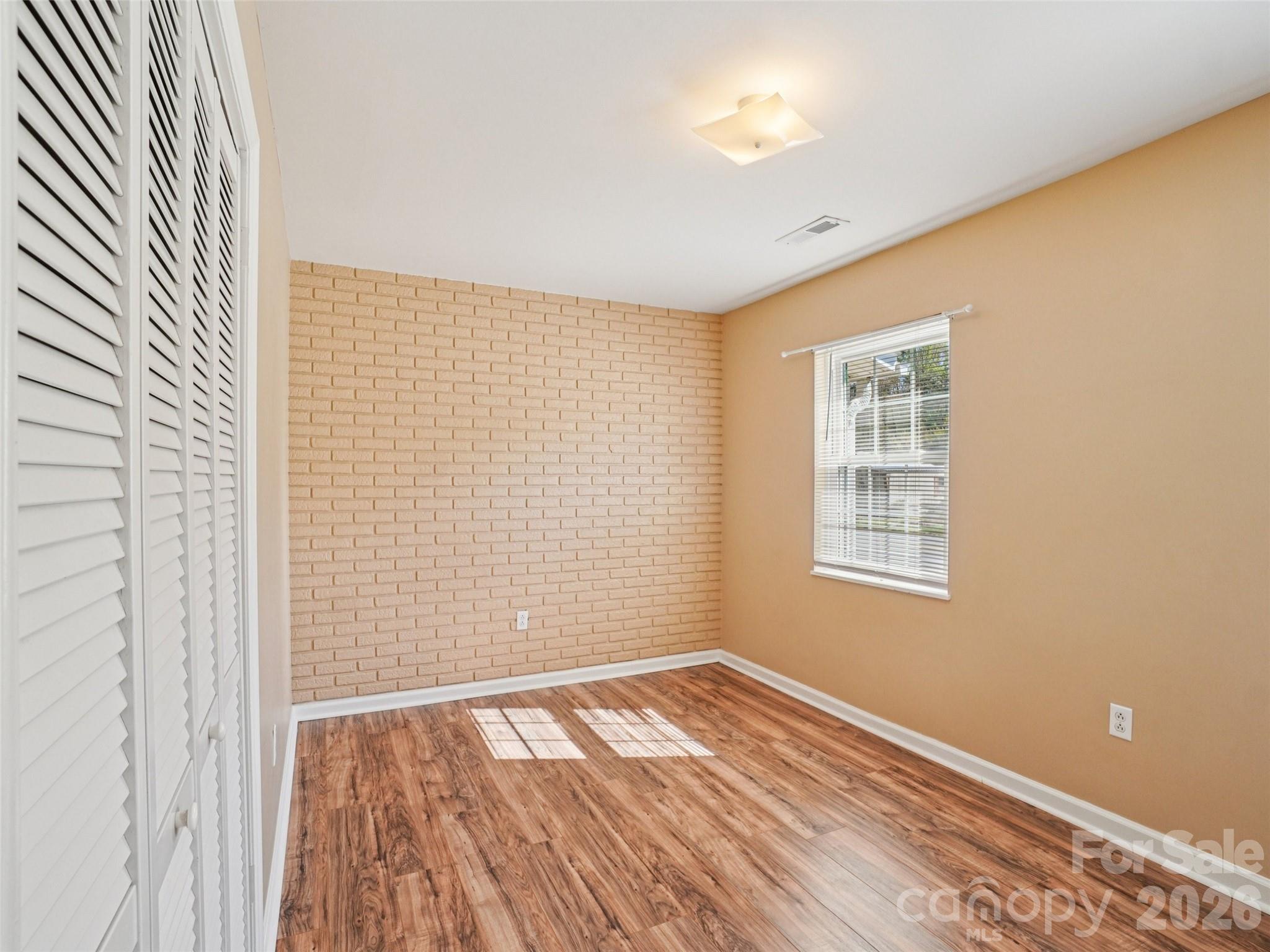 88 Lees Creek Road Asheville, NC 28806 - Photo 12 of 29 a view of empty room with wooden floor and fan