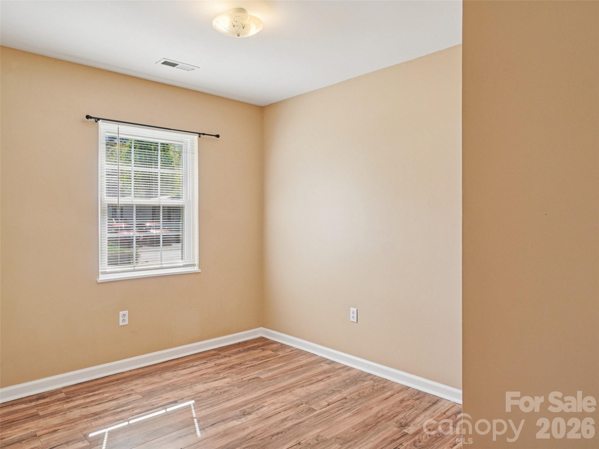 88 Lees Creek Road Asheville, NC 28806 - Photo 14 of 29 a view of an empty room with wooden floor and a window