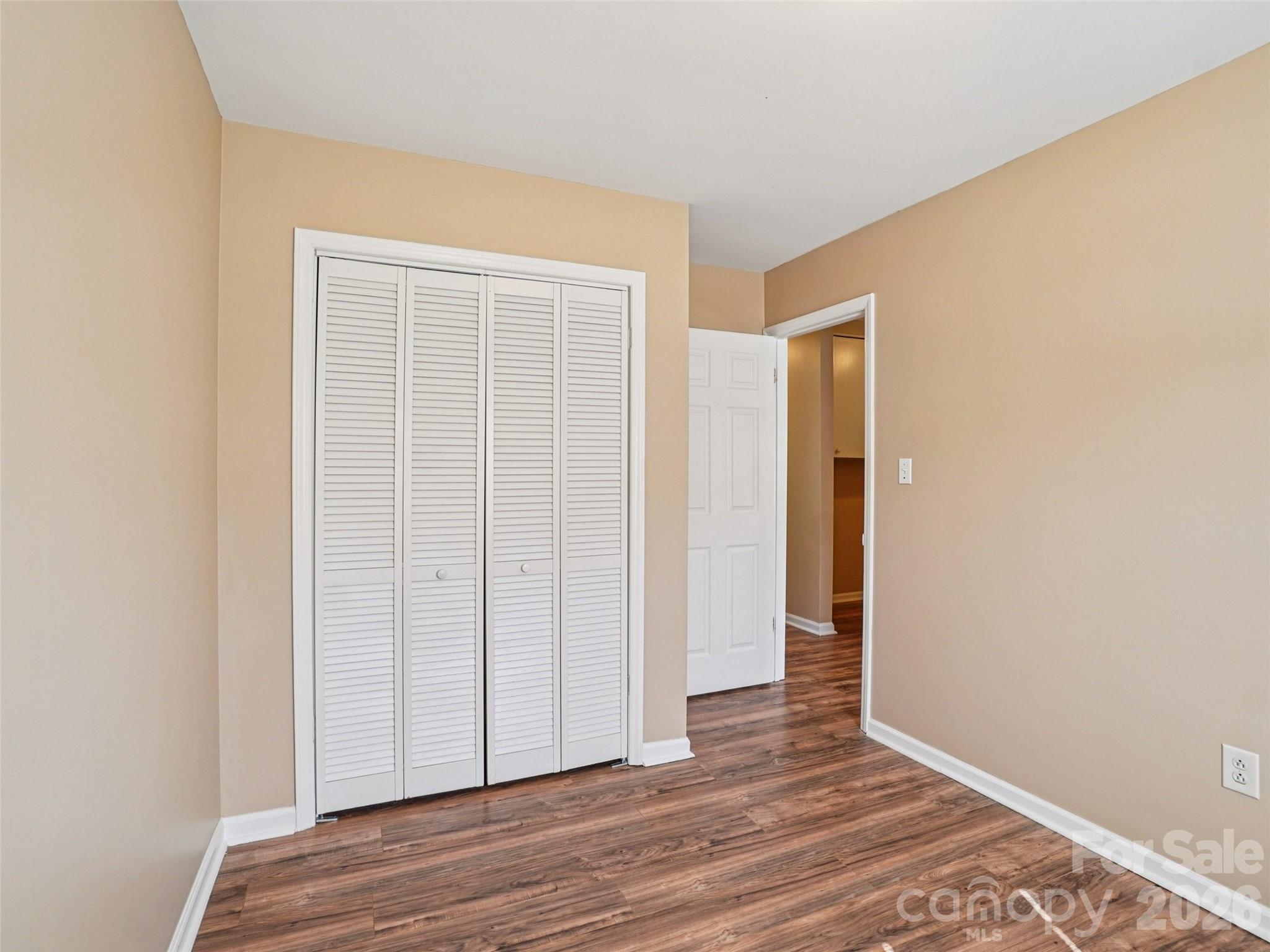 88 Lees Creek Road Asheville, NC 28806 - Photo 15 of 29 an empty room with wooden floor and closet