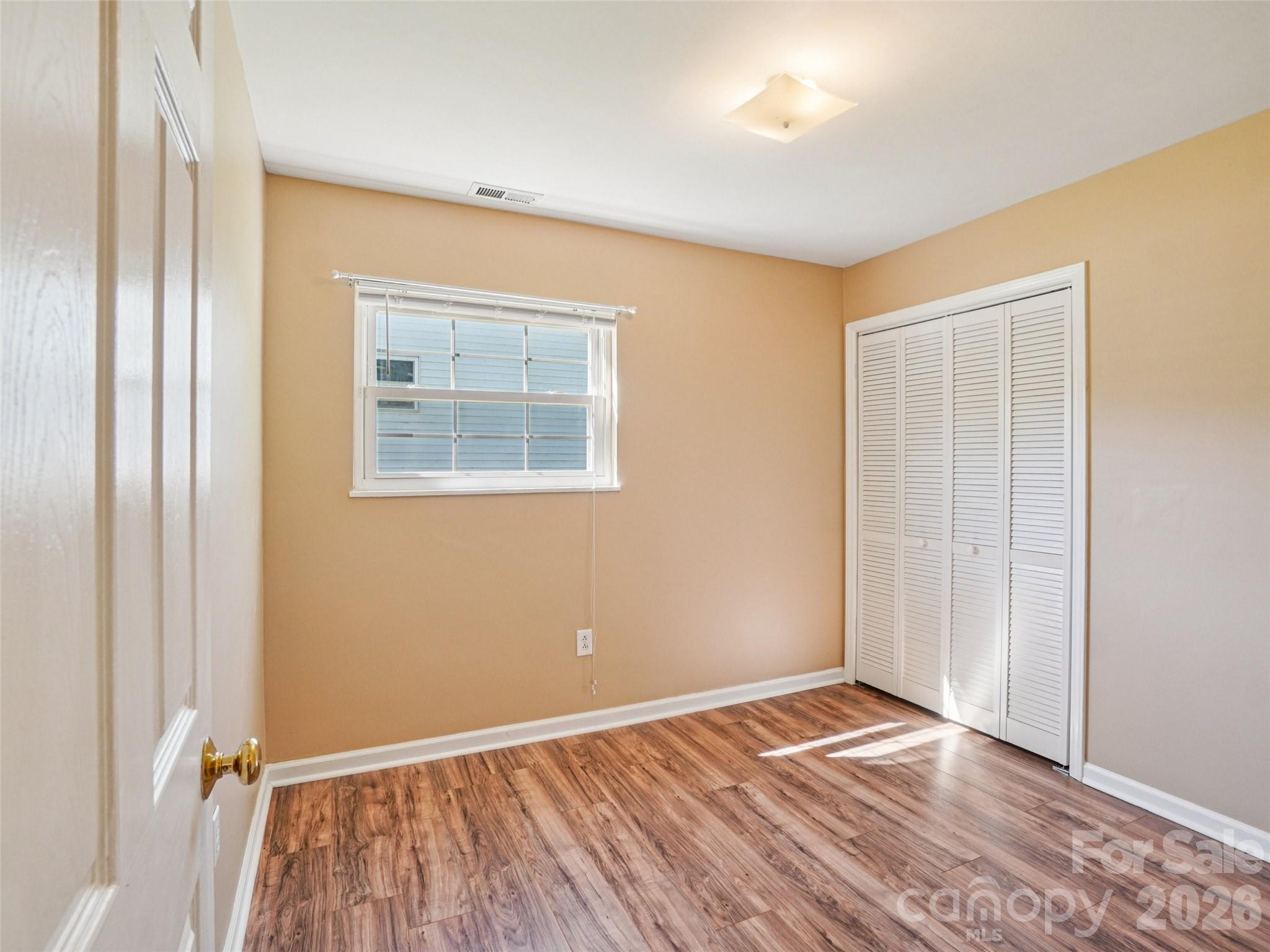 88 Lees Creek Road Asheville, NC 28806 - Photo 16 of 29 an empty room with wooden floor and a window