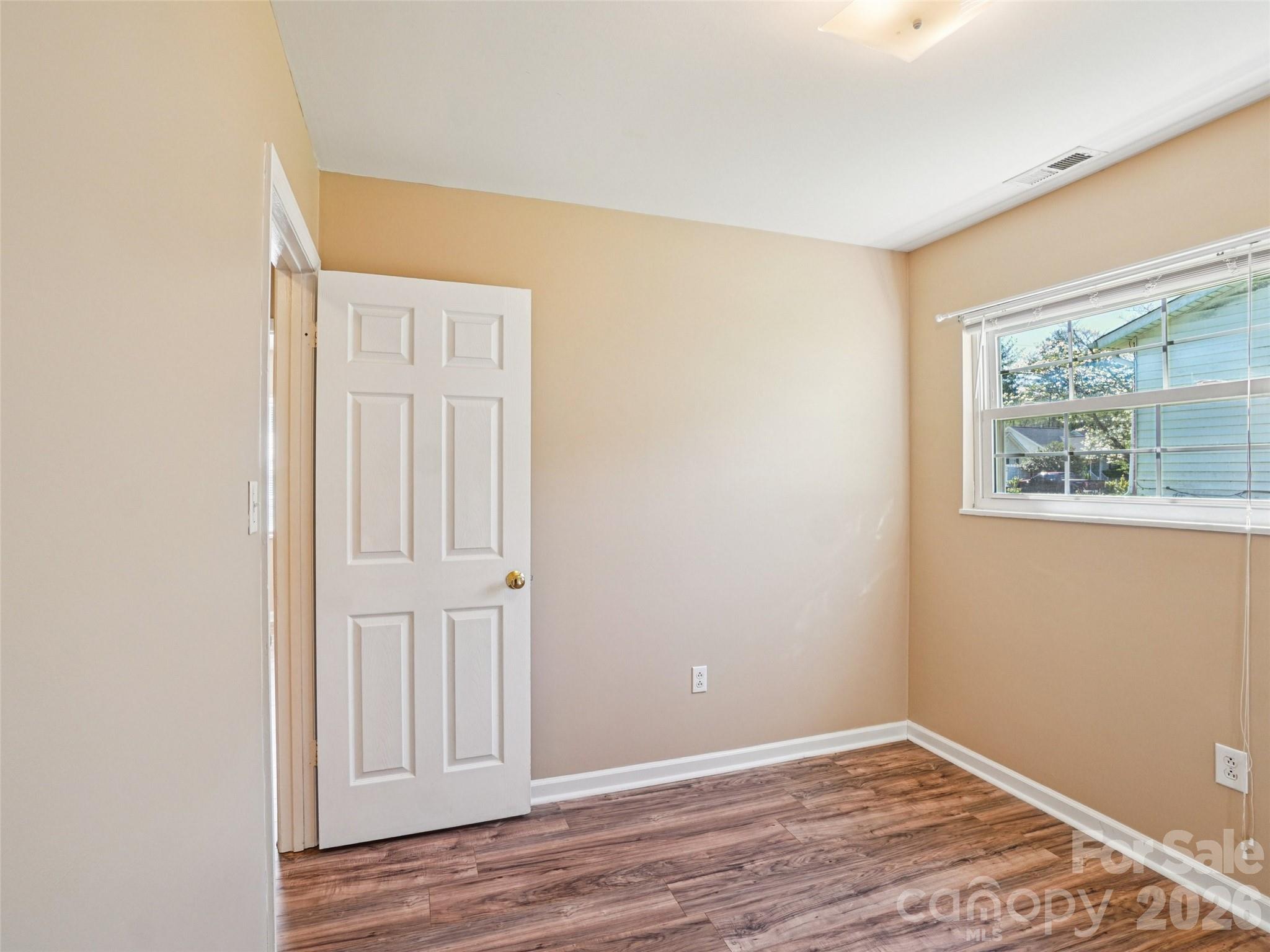 88 Lees Creek Road Asheville, NC 28806 - Photo 17 of 29 an empty room with wooden floor closet and windows