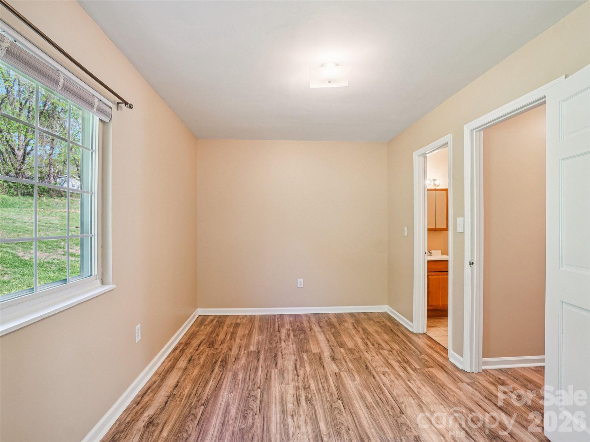 88 Lees Creek Road Asheville, NC 28806 - Photo 20 of 29 a view of a room with wooden floor and windows