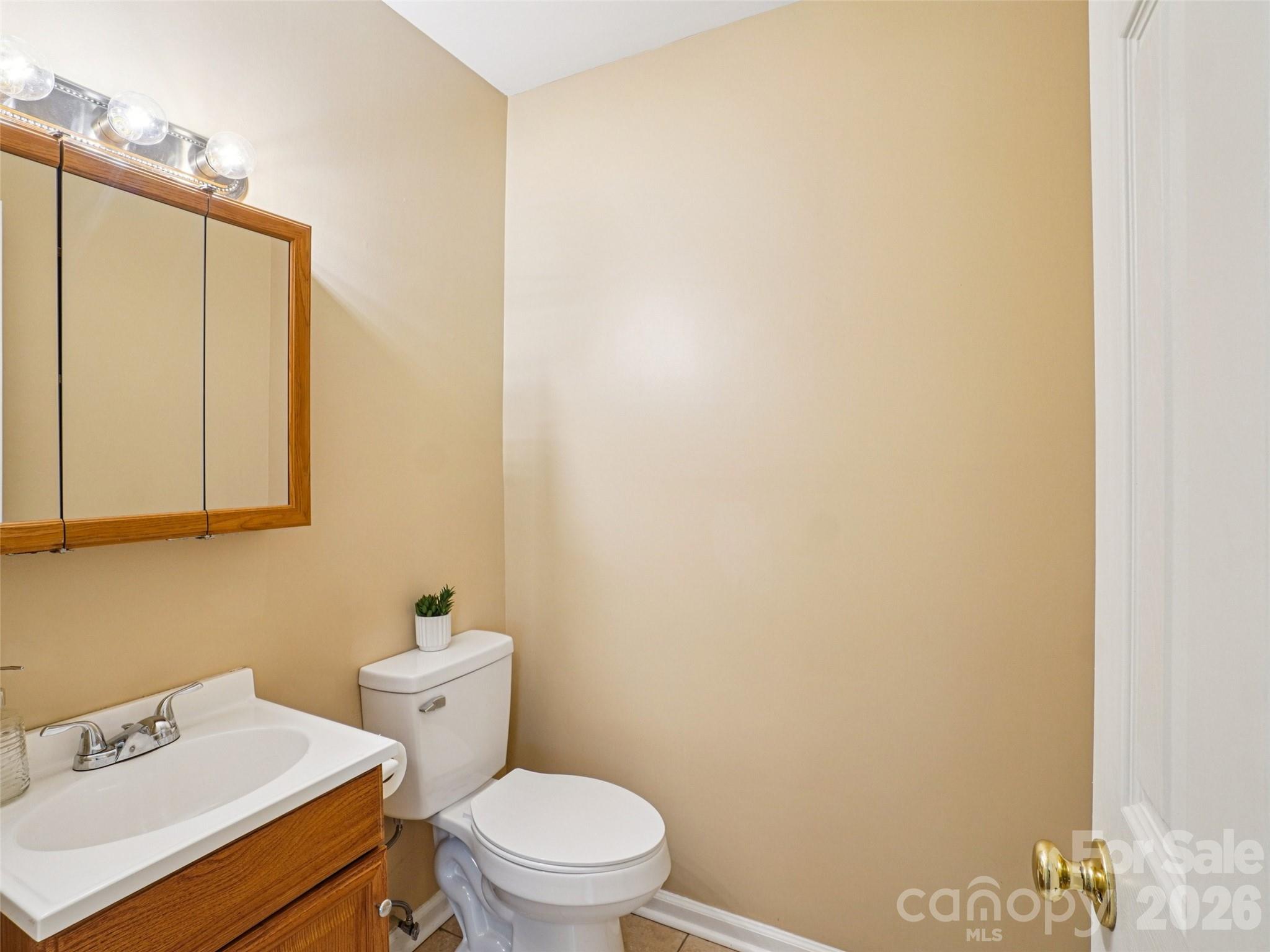 88 Lees Creek Road Asheville, NC 28806 - Photo 21 of 29 a white toilet sitting next to a bathroom sink