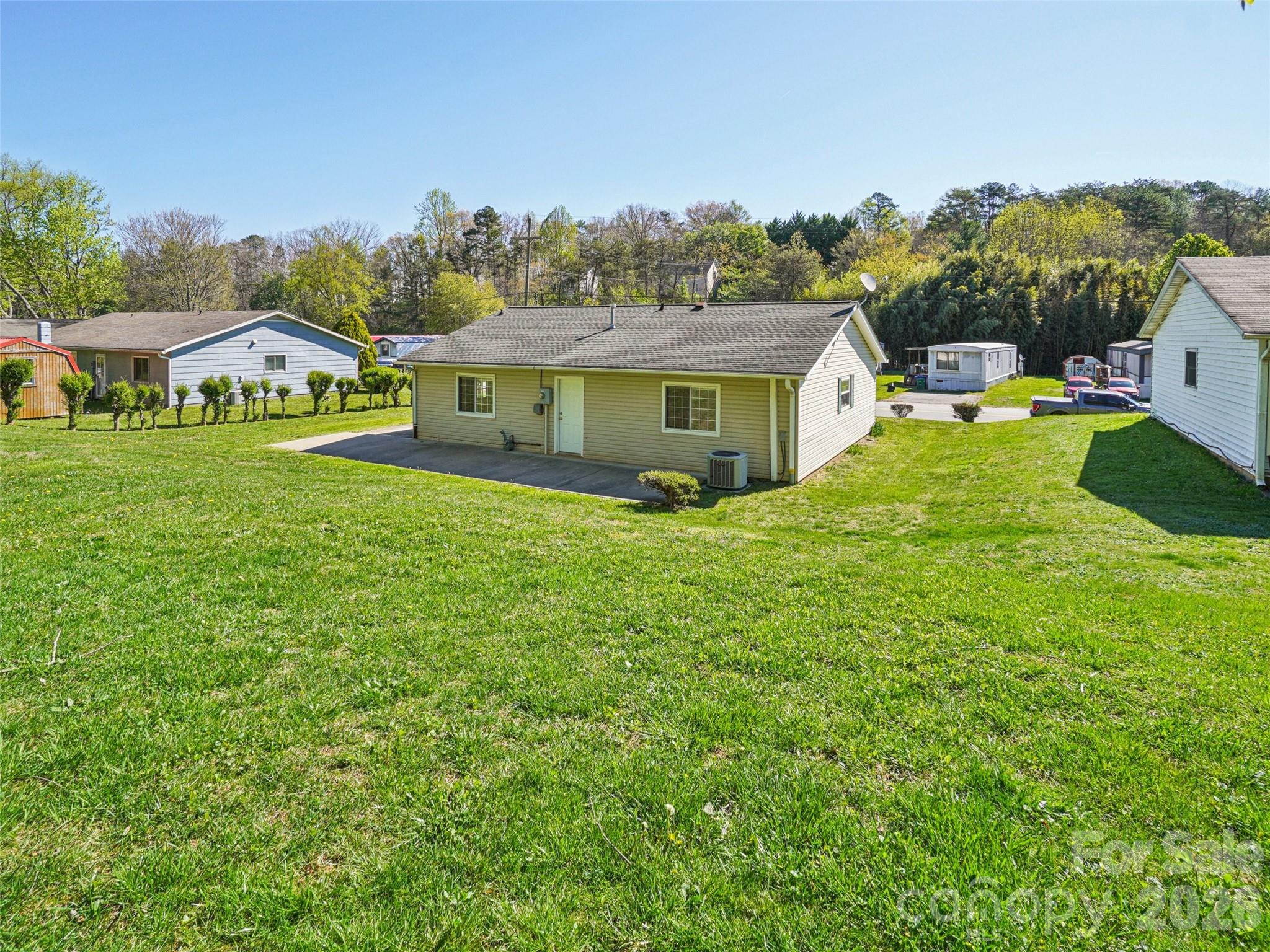 88 Lees Creek Road Asheville, NC 28806 - Photo 29 of 29 a view of a big house with a big yard and large trees