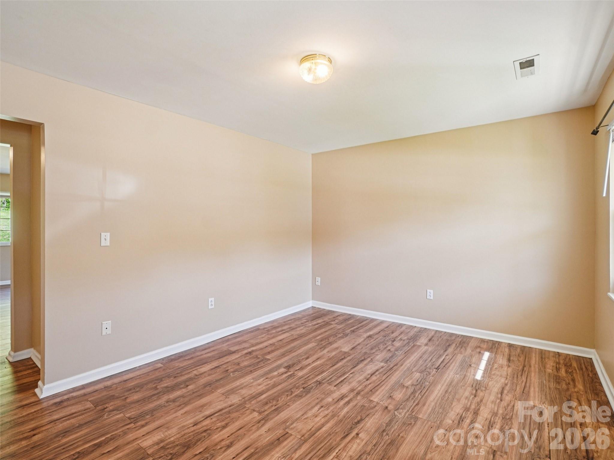 88 Lees Creek Road Asheville, NC 28806 - Photo 6 of 29 wooden floor in an empty room with a window