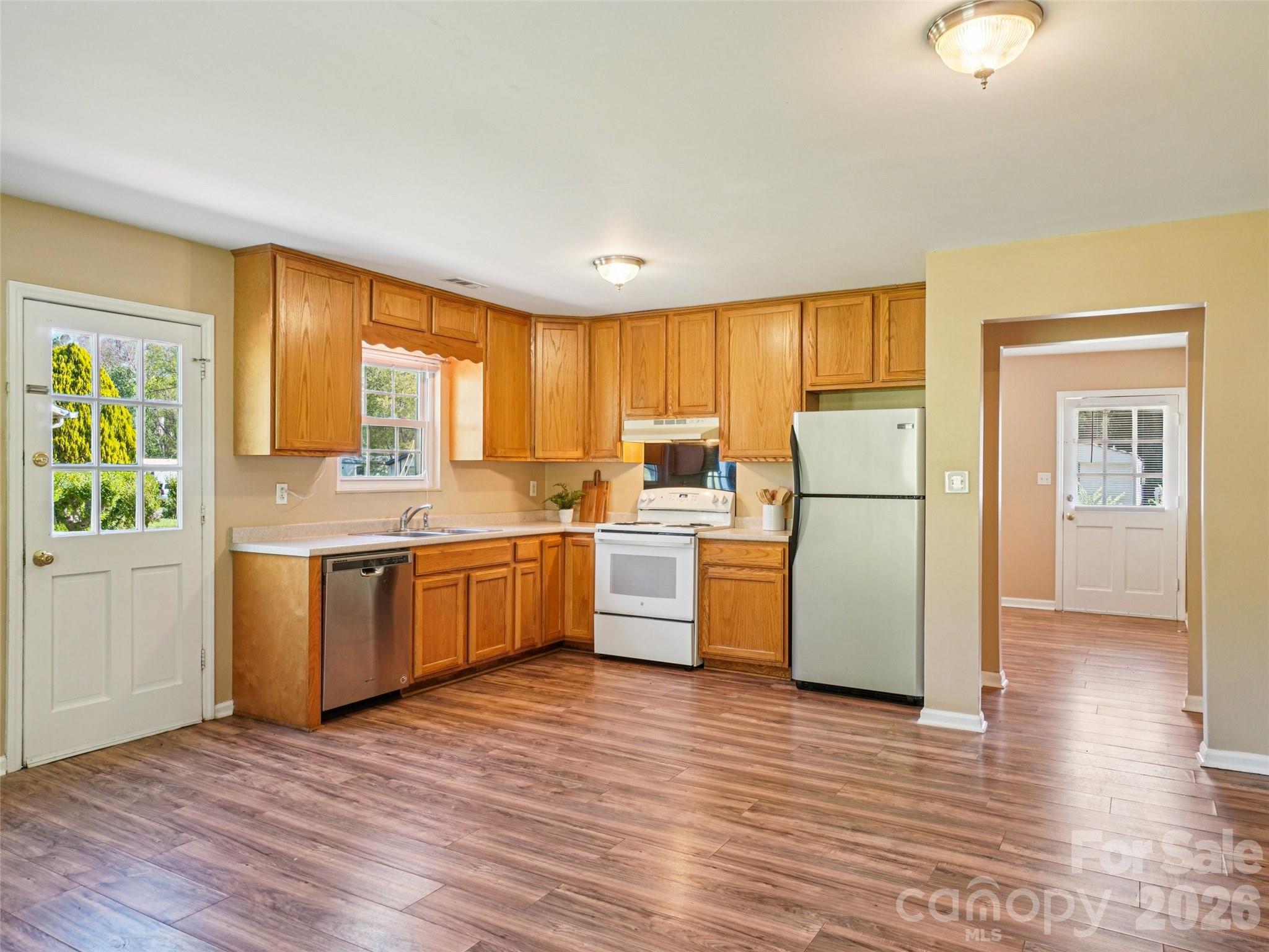 88 Lees Creek Road Asheville, NC 28806 - Photo 8 of 29 a kitchen with a refrigerator and a stove top oven