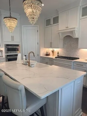 a kitchen with a sink a stove and cabinets
