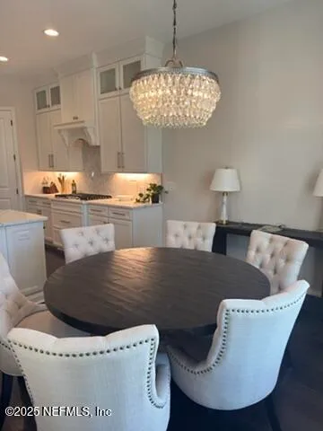 a kitchen with a table and chairs