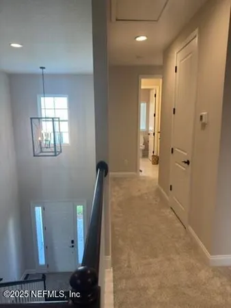 a view of a hallway with windows