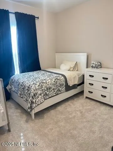 a bedroom with a bed and a night stand