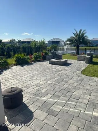 a view of swimming pool with seating space and yard in back