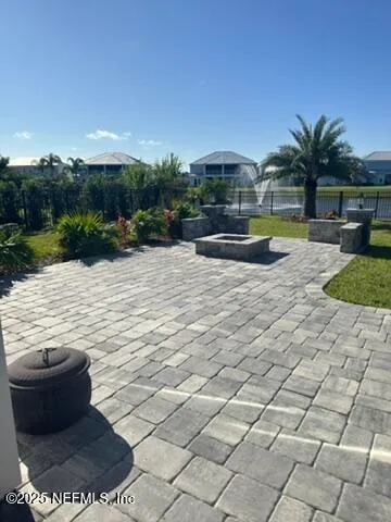 a view of swimming pool with seating space and yard in back
