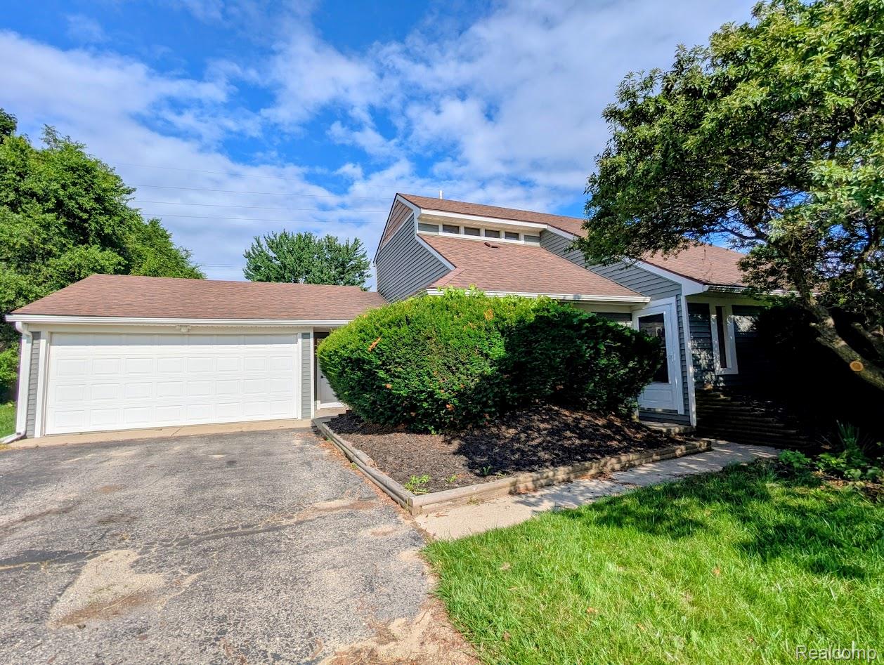 2316 Crescent Lake Road Waterford, MI 48329 - Photo 1 of 17 Split-level residence featuring gray siding and a brown shingle roof