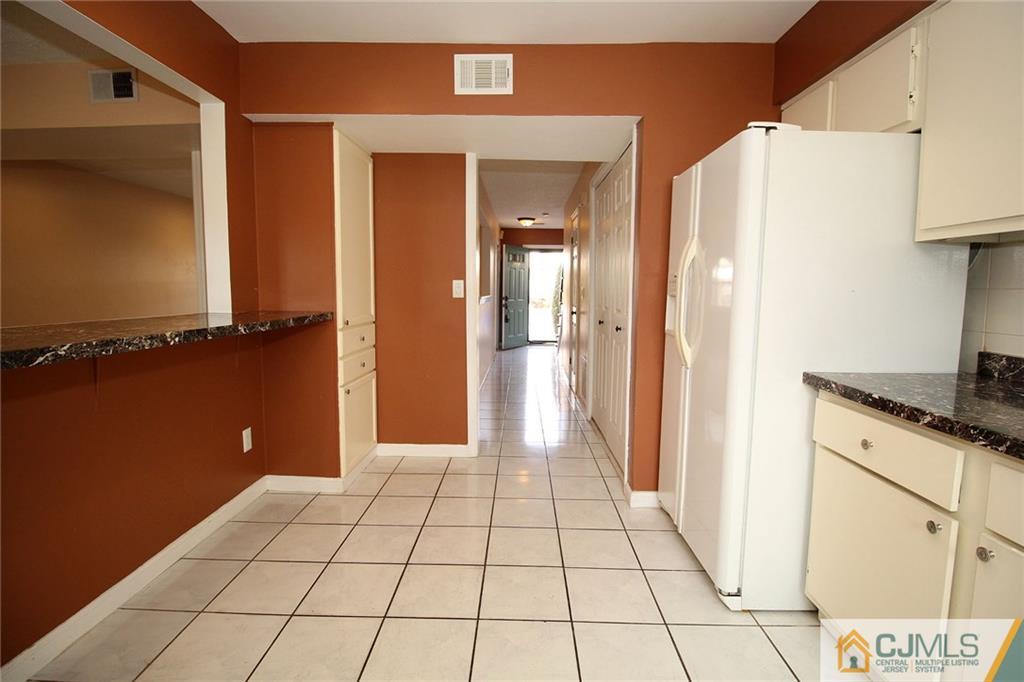 5203 Hana Road Edison, NJ 08817 - Photo 11 of 25 a view of a kitchen from the hallway