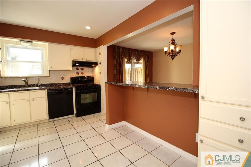 5203 Hana Road Edison, NJ 08817 - Photo 12 of 25 a kitchen with stainless steel appliances granite countertop a refrigerator and a stove