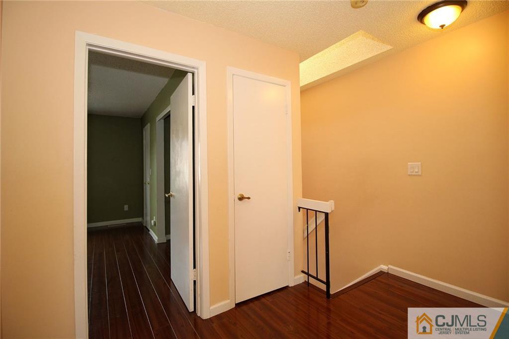 5203 Hana Road Edison, NJ 08817 - Photo 16 of 25 a view of hallway with wooden floor