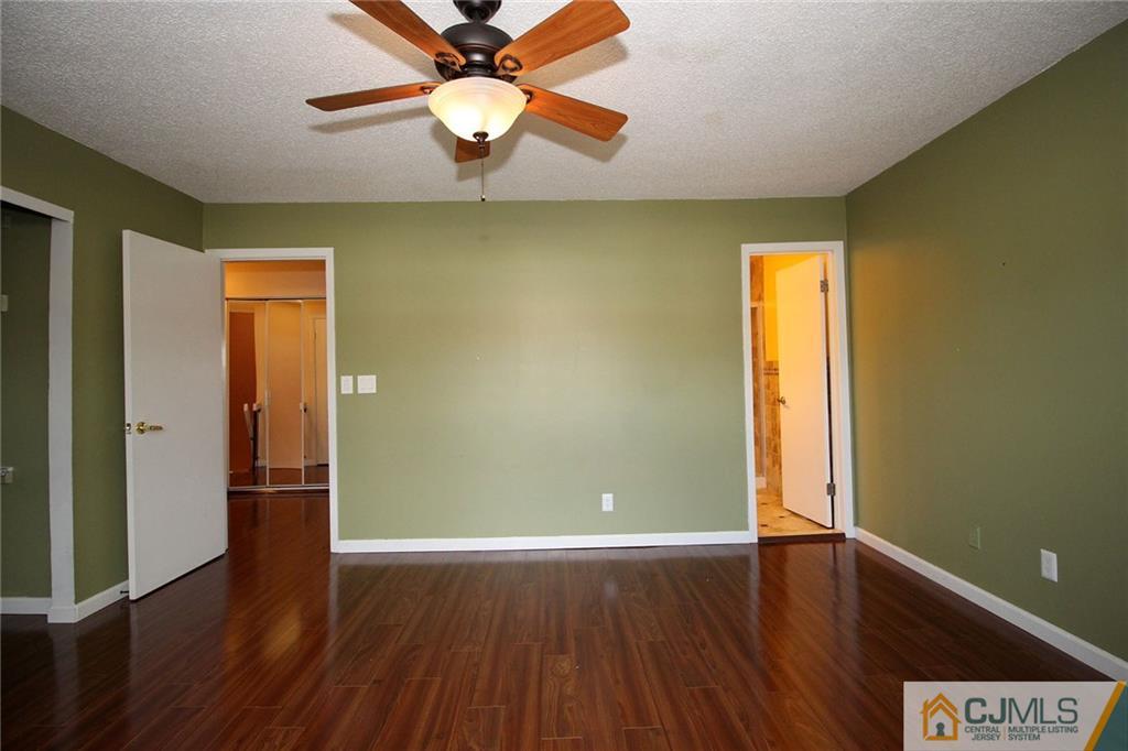 5203 Hana Road Edison, NJ 08817 - Photo 18 of 25 an empty room with wooden floor and windows