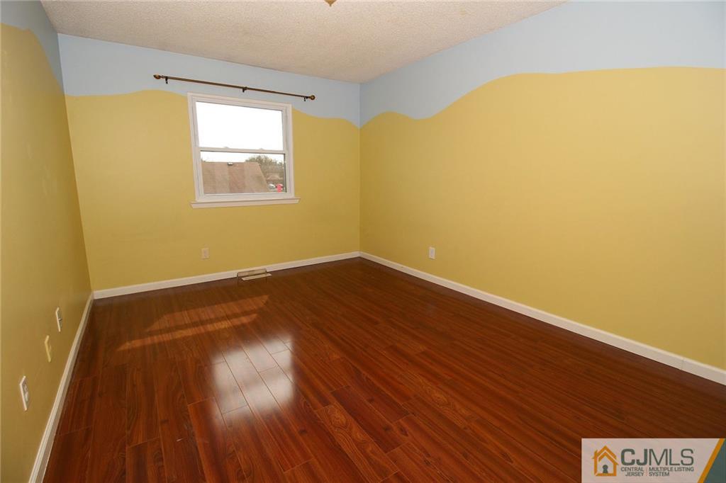 5203 Hana Road Edison, NJ 08817 - Photo 20 of 25 a view of a room with wooden floor and a window