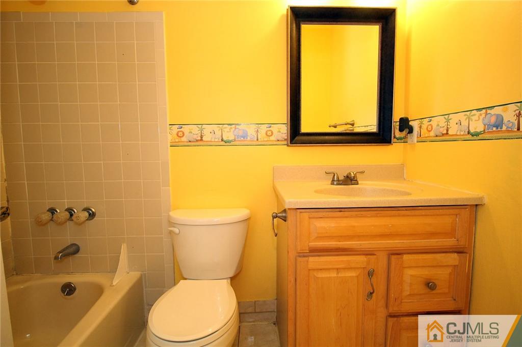 5203 Hana Road Edison, NJ 08817 - Photo 22 of 25 a bathroom with a granite countertop sink toilet and shower