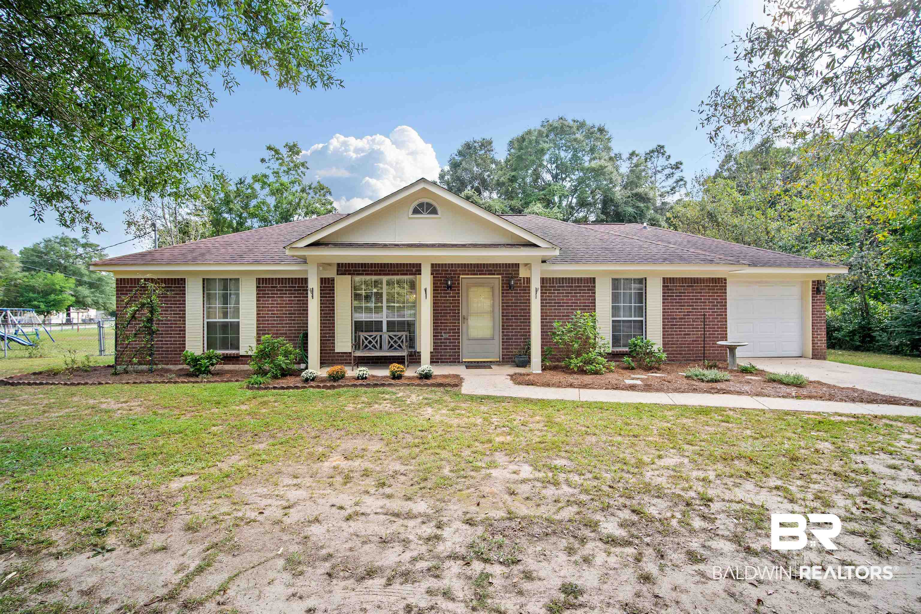11191 Old Moffat Road Wilmer, AL 36587 - Photo 1 of 30 Ranch-style home featuring a front lawn, covered porch, and a garage