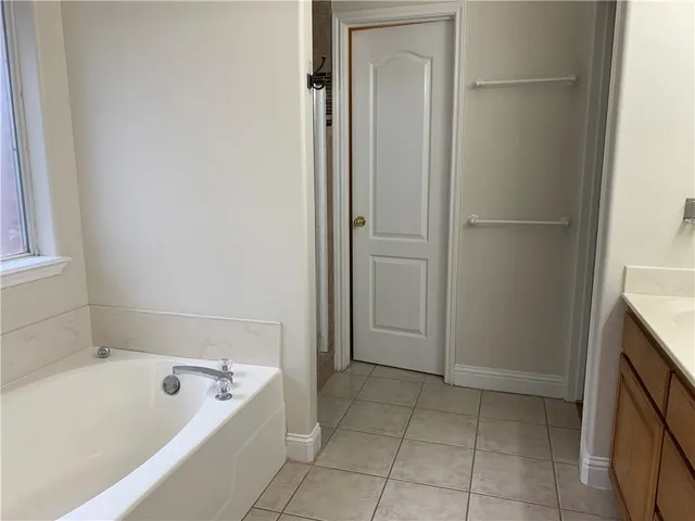 a bathroom with a tub shower and sink