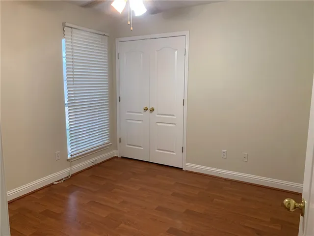 an empty room with an entryway and closet